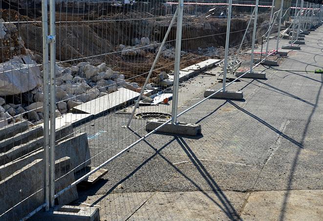 temporary fence panels providing a barrier to keep work areas safe and contained